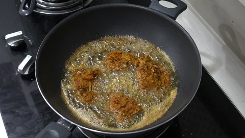 Frying a herbs chicken in a wok Stock Footage 101108236