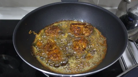 Frying a herbs chicken in a wok Stock Footage 101110009