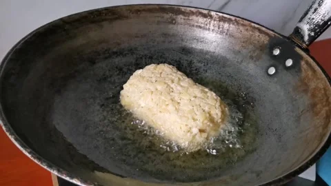 Frying Homemade Raw Hash Brown Potatoes on a Frying Pan Stock Footage 241511518