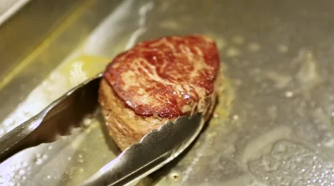 Frying a juicy steak Stock Footage 60443167