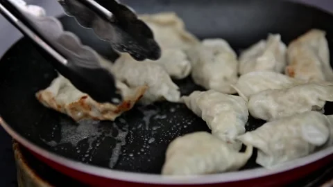 Frying kuotie until behind the back, street food Stock Footage 273040677