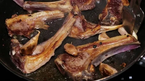 Frying lamb chops with olive oil, pepper and garlic Stock Footage 132601825