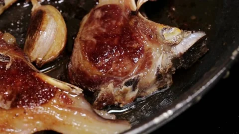 Frying lamb chops with olive oil, pepper and garlic Stock Footage 132601884