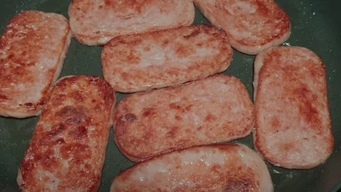 Frying Luncheon Meat Slices Cooking in a Hot Skillet Stock Footage 320131087