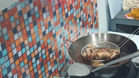 Frying Mackerel Fish in Deep Oil Using a Carbon Steel Wok Video stock 326613694