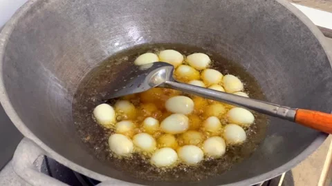 Frying many fresh quail eggs in a large pan with hot boiling oil Stock Footage 327227858