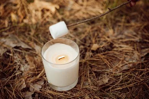 Frying marshmallows on a white candle Stock Photos