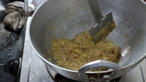 Frying of mashed onion in mustard oil in a hindalium utensil till it gets golden Stock Footage 121698593