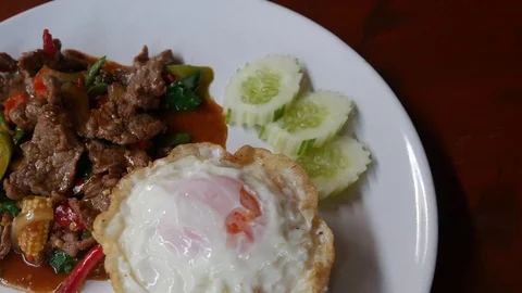 Frying meat with basil leaves with cooked rice and Fried egg. Stock Footage 88424158