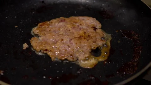Frying meat cutlet close-up. Homemade cutlet is cooked in a frying pan Video stock 145367673