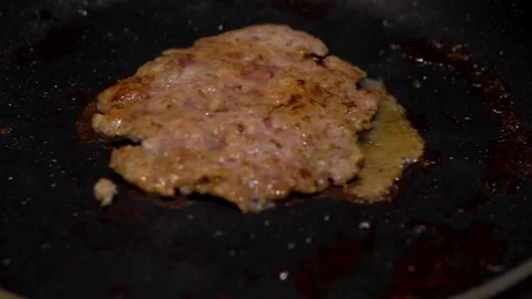 Frying meat cutlet close-up. Homemade cutlet is cooked in a frying pan Stock Footage 145402925