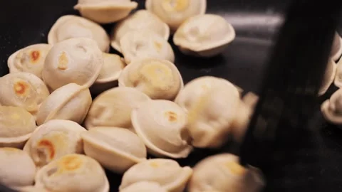 Frying meat dumplings in a hot frying pan. 스톡 동영상 335140480