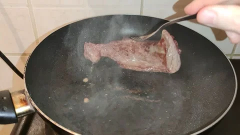 Frying meat in the frying pan 動画素材 240958931
