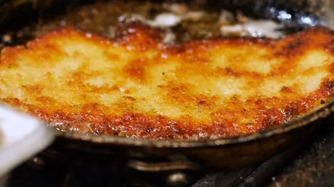 Frying meat on sizzling oil Stock Footage 127930031