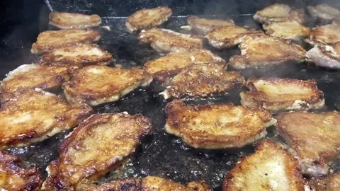 Frying meat in slowmotion Stock Footage