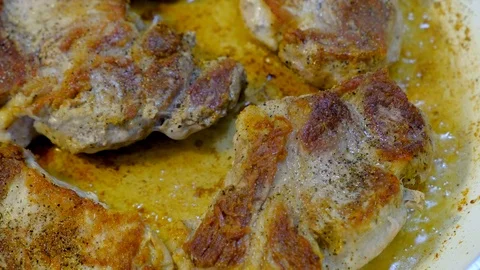 Frying meat steaks in a pan Stock Footage 109012882