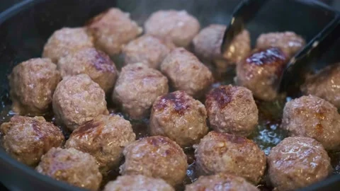 Frying meatballs in black pan. Stock Footage 160341232
