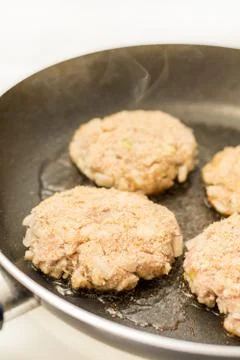 Frying meatballs of minced meat with onions in the frying pan Stock Photos