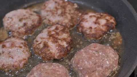 Frying meatballs in pan slow motion food Stock Footage 114077332