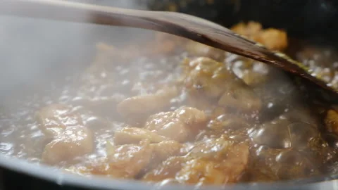 Frying meet in pan with sauce Close up Cooking. Stock Footage 131054297