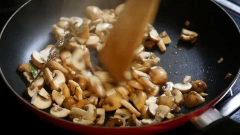 Frying mushrooms in a pan Stock Footage 73927832
