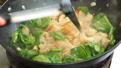Frying noodle with chopped chicken and Chinese kale in pan, Thai street food Stock-Footage 108829987