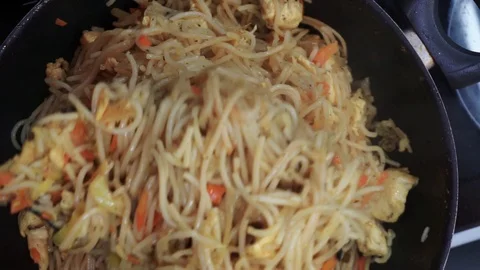 Frying noodles overhead Stock Footage 98361177