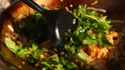 Frying noodles with pork and basil in pan Stock Footage 89573589