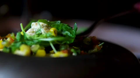 Frying an omelet with eggs, zucchini, and arugula in a pan in the kitchen. Stock Footage 307743411