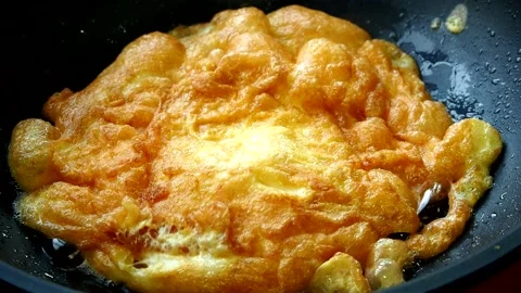 Frying omelet in pan, in door  Chiangmai Thailand Stock Footage 221007170