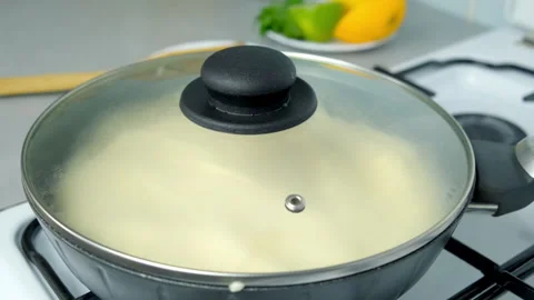 Frying omelet whipped mass in frying pan under lid cooking on kitchen gas stove. Stock Footage 313130403