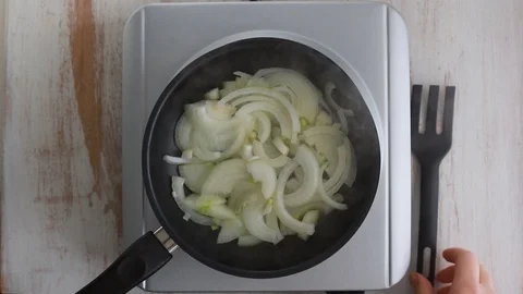 Frying onion on frying pan Video stock 100635858