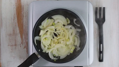 Frying onion on frying pan Video stock 100635884