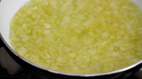 Frying onion in oil Stock Footage 81718828