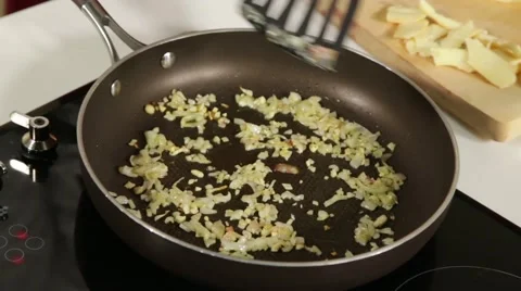 Frying onion on a pan Stock Footage 49781729