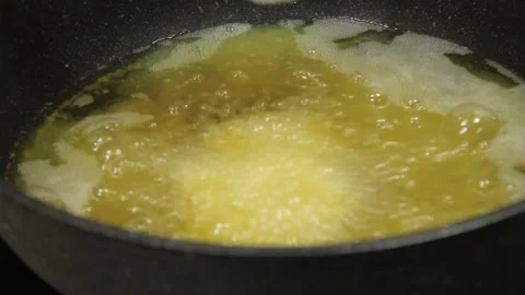 Frying onion rings. someone is cooking onion rings 動画素材 334268427