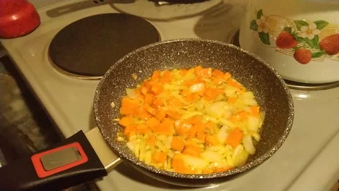 Frying onions and carrots Stock Footage 153647061