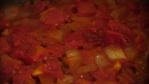 Frying Onions and Tomatoes in Pan Stock Footage 199506843