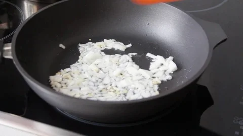 Frying onions in a frying pan Stock Footage 72610486