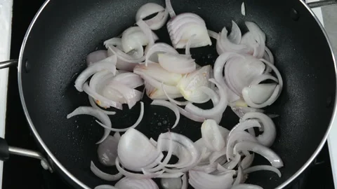 Frying onions in a frying pan Stock Footage 137801534