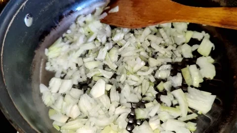 Frying onions in a frying pan Stock Footage 227721698