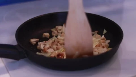 Frying onions with mushrooms in a pan. Cooking process Stock Footage 169252653