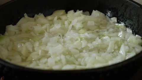 Frying onions in a pan with oil. Stock Footage 165872567