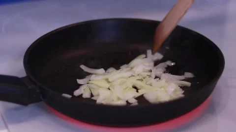Frying onions in a skillet Video stock 169253032