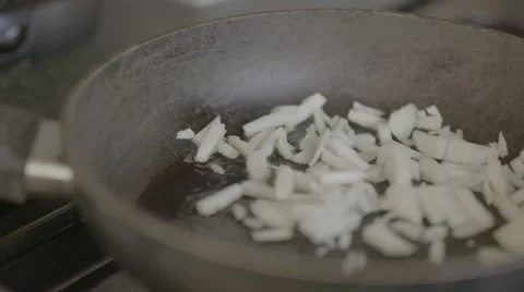 Frying onions, slow motion, panning shot Stock Footage 56778020