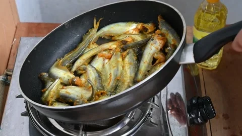 Frying pabda fish in hot oil. Slow motion video Stock Footage 209134149