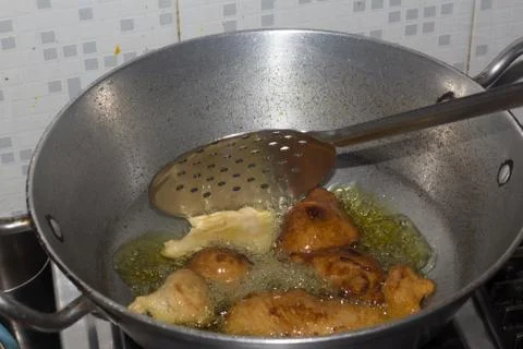 Frying pakode in pan with oil, very popular street food in India. Stock Photos
