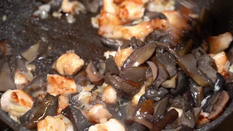 In a frying pan, boiled forest mushrooms, fried meat and onions Stock Footage 248228699