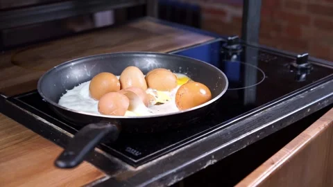 Frying pan contains fried eggs and scattered eggshells Stock Footage 274240942