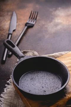 Frying pan on a cutting board. Stock Photos